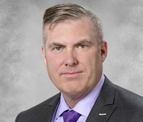 A headshot of a male lawyer wearing a suit and tie. Representing how one can benefit from calling a Portland criminal defense attorney.