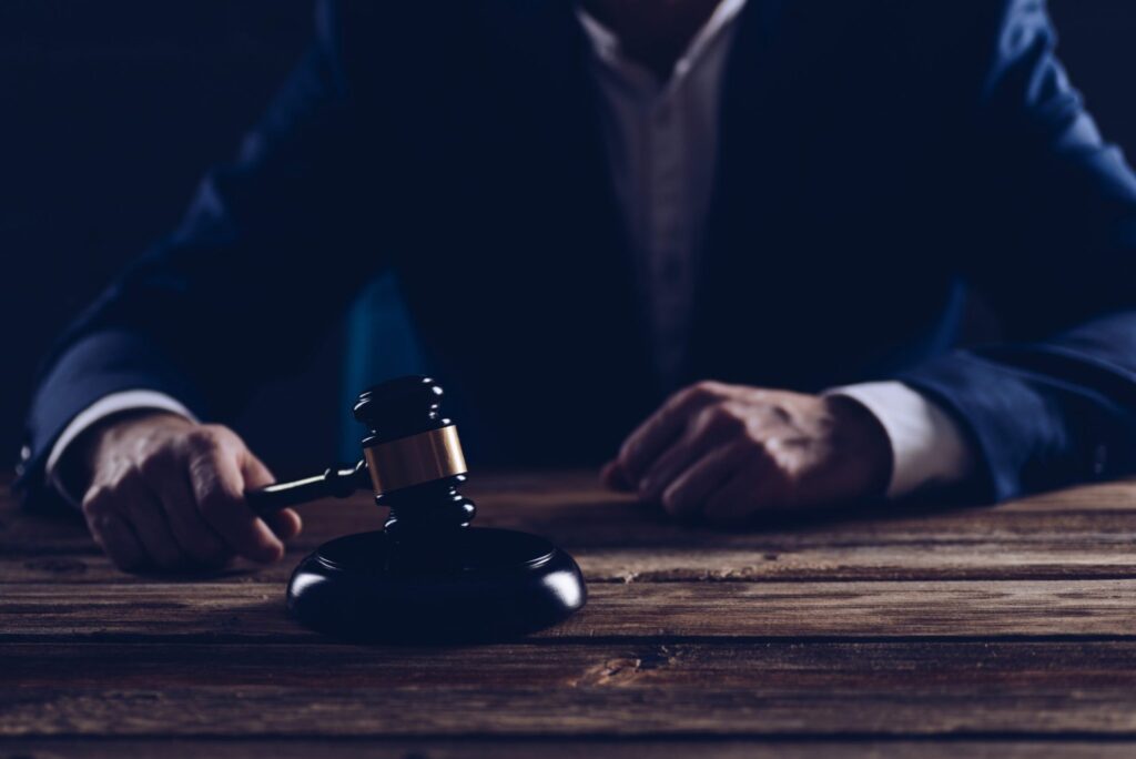 A judge hitting a gavel on a block, representing how one can benefit from calling a Portland criminal defense attorney.