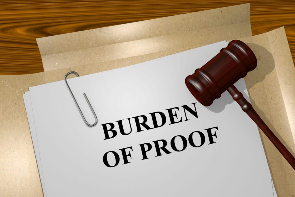 A judge's gavel and a piece of paper that says "Burden of Proof", representing how one can benefit from calling a Portland criminal defense attorney.