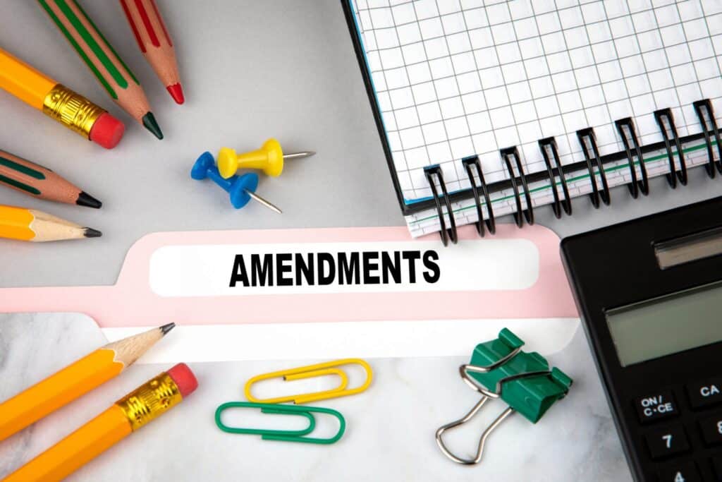 A folder on a desk labeled "Amendments" there are clips, pins and pencils around it. Representing how one can benefit from calling a Portland criminal defense attorney.