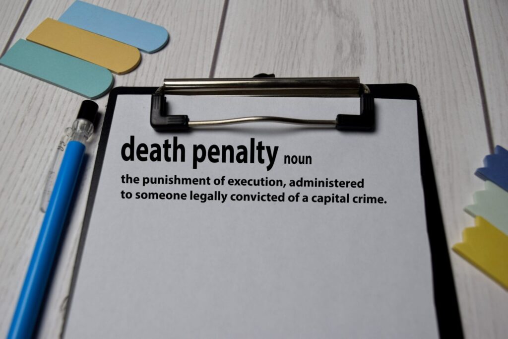 A clipboard with a page that has the definition of "Death Penalty", representing how one can benefit from calling a Portland criminal defense lawyer.