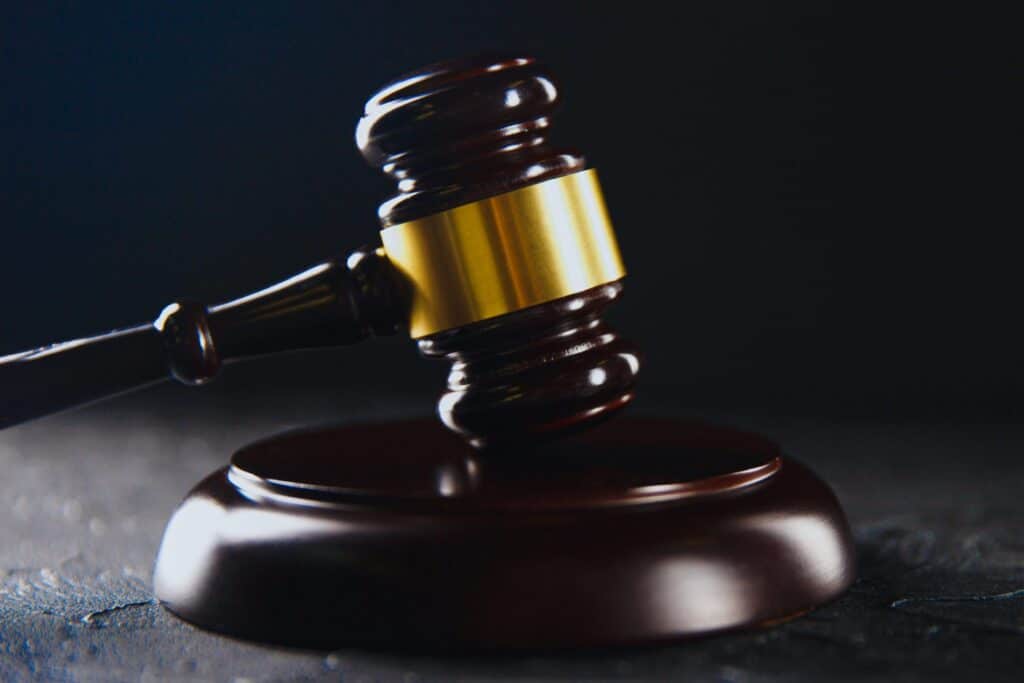 A judge's gavel resting on a block over a dark background representing how one can benefit from calling a Portland criminal defense attorney.