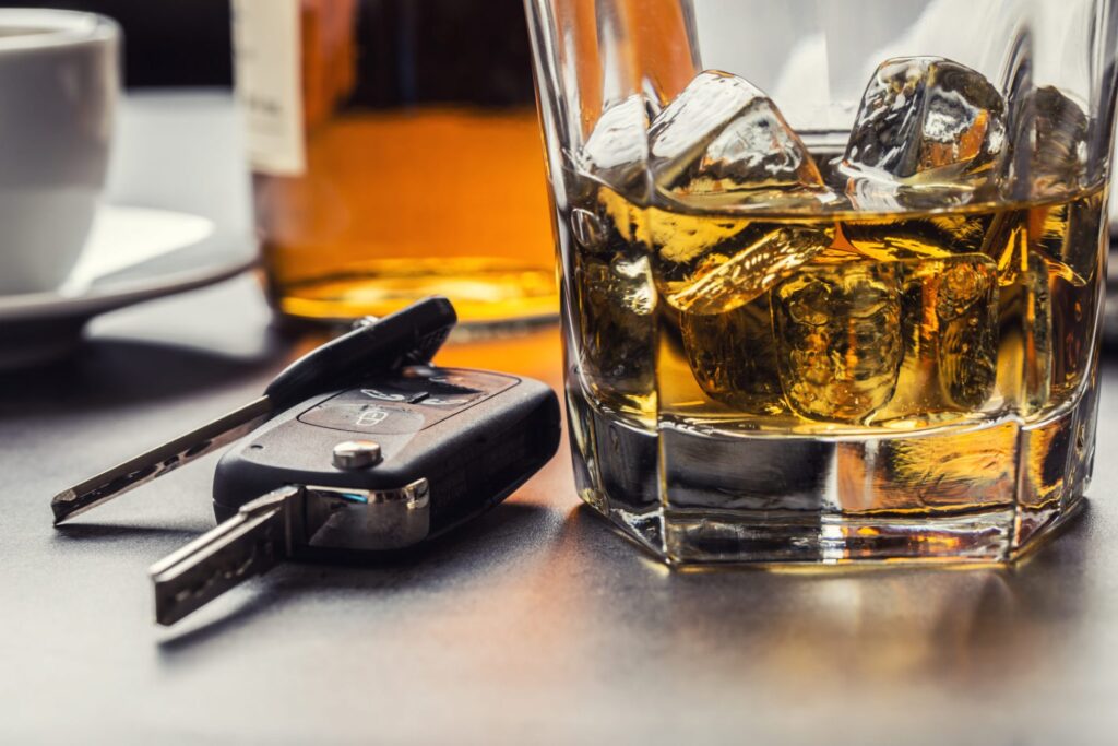 An alcoholic beverage next to a set of car keys, representing how one can benefit from contacting a Portland criminal defense lawyer.