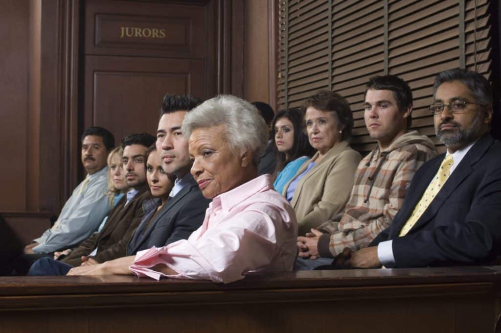 A group of jurors actively listening, representing how one can benefit from calling a Portland criminal defense lawyer.