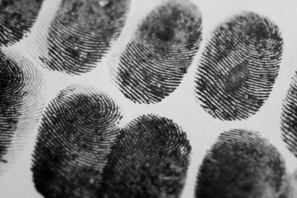 A white piece of paper with multiple dark finger prints, representing how one can benefit from calling a Portland criminal defense lawyer.
