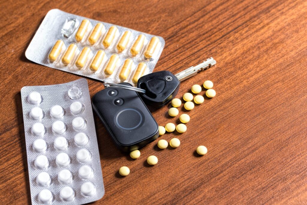 Two different types of pills and a set of car keys, representing how one can benefit from calling a Portland criminal defense lawyer.