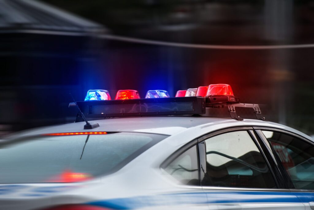 A police car with the lights on, representing how one can benefit from calling a Portland criminal defense lawyer.