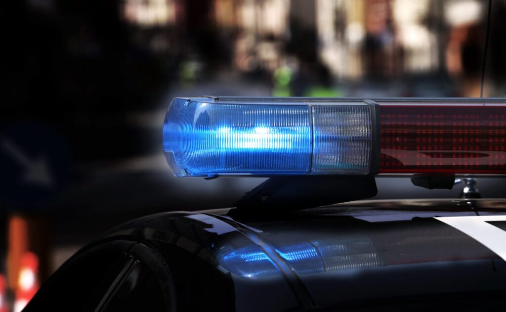 A police car with the lights on, representing how one can benefit from calling a Portland criminal defense lawyer.