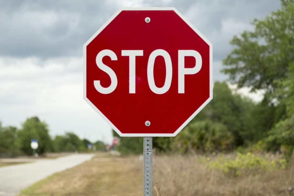 A red stop sign in the road, representing how one can benefit from calling a Portland criminal defense lawyer.