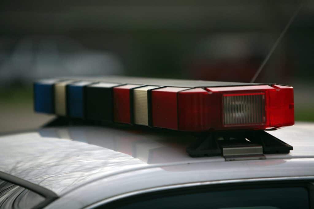 The blue and red lights of a police car, representing how one can benefit from calling a Portland criminal defense lawyer.