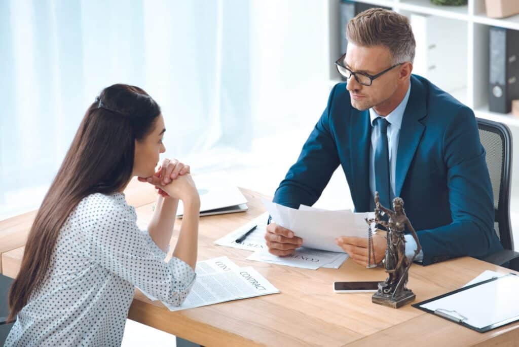 A lawyer explaining information to a client, representing how one can benefit from calling a Portland criminal defense lawyer.