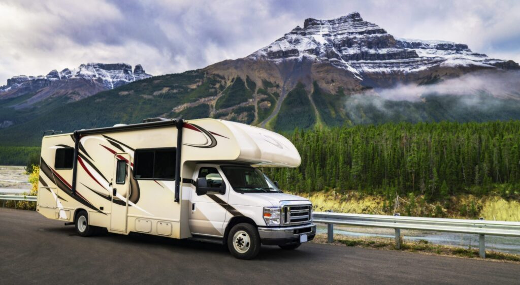 A recreational vehicle driving on the road close to a mountain, representing how one can benefit from calling a Portland criminal defense lawyer.