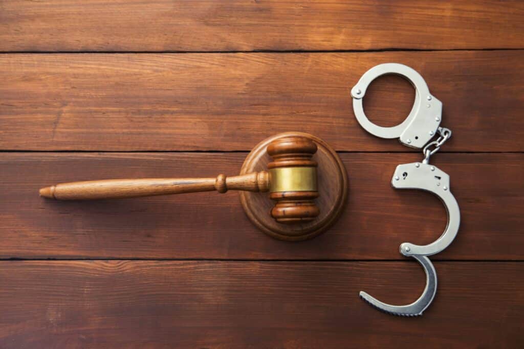 Judge's gavel and a set of handcuffs next to it, representing how one can benefit from calling a Portland criminal defense lawyer.