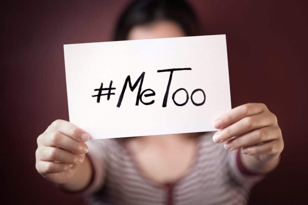 A women holding a white piece of paper that says "#MeToo" representing how one can benefit from calling a Portland criminal defense lawyer,