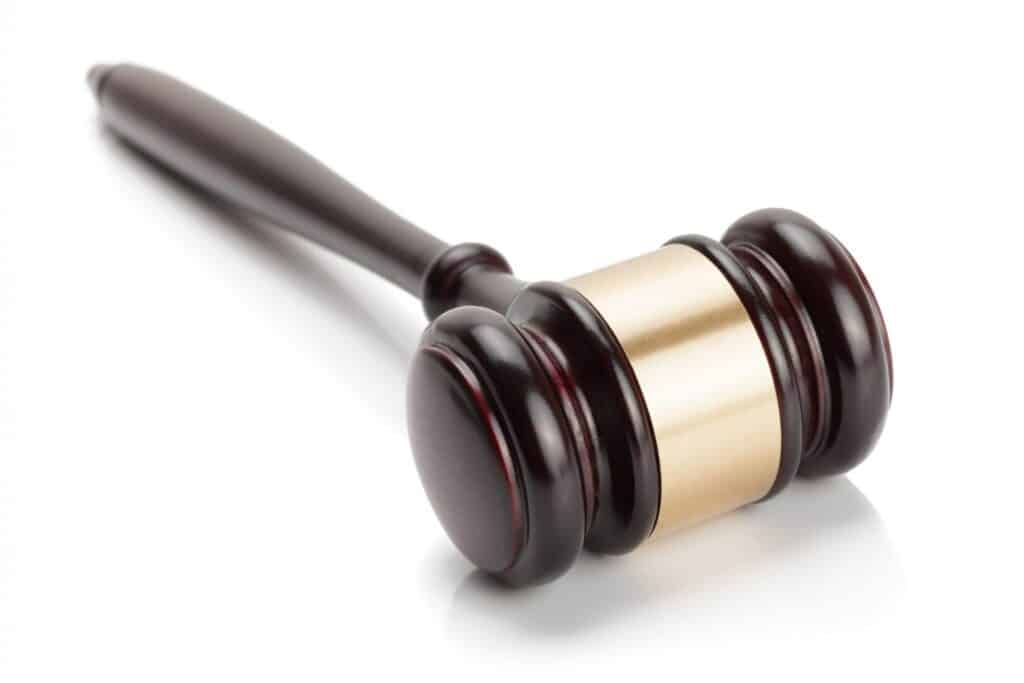 Judge's gavel over a white background, representing how one can benefit from calling a Portland criminal defense lawyer.
